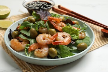 Delicious shrimp salad served on white table, closeup