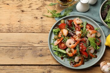 Delicious shrimp salad with ingredients on wooden table, flat lay. Space for text
