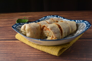 Homemade traditional asian food nyonya Popiah Spring Roll fresh vegetables, bean curd, fried shallots, dried shrimp, sweet chili paste and braised turnip on wood table vegan halal menu for cafe