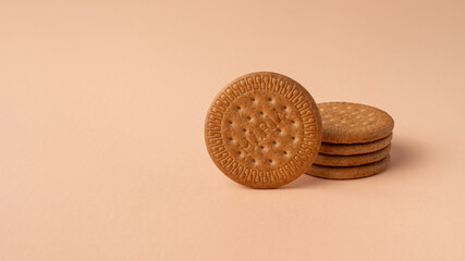 Maria biscuits on pink beige background. Trendy color of the year 2024 - Peach Fuzz. Copy space