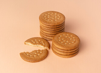 Maria biscuits on pink beige background. Trendy color of the year 2024 - Peach Fuzz.