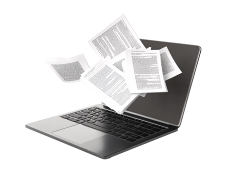 a laptop with papers flying out of it