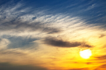 captivating twilight sky with bold streaks of orange and gold fading into a dark blue, creating a breathtaking backdrop that signifies the end of a beautiful day