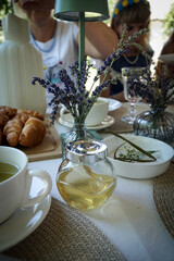 The table in the country house is decorated with lavender