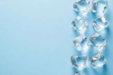 Crystal clear ice cubes on blue background with copy space