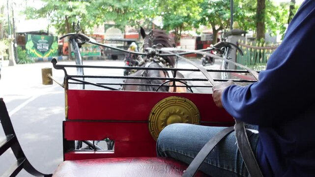Dokar or horse-drawn carriage transports tourists to tourist attractions in Indonesia