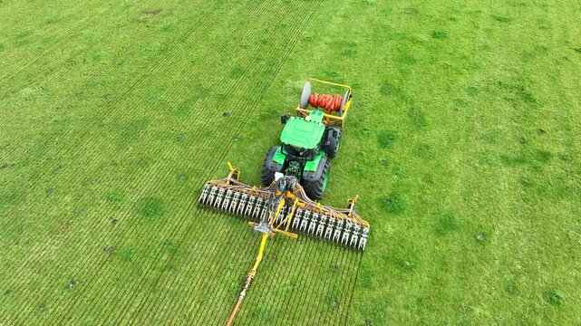 Liquid manure spreader injecting livestock liquid manure with in a field seen from above during springtime using a drag hose injector to minimalize the compaction of the soil during fertilisation.