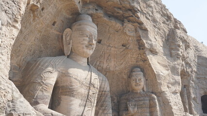 View from side of two Stone Buddhas bodies in Yungang caves and graves in Datong in China