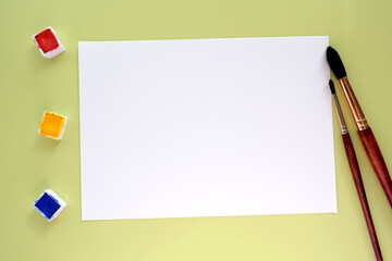 mock-up white paper blank watercolour painting with brushes and paints