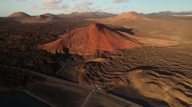 Aerial view of the beautiful volcanic landscape featuring Volcan Bermeja and Tiny Charco Verde lake, El Golfo, Lanzarote, Canary Islands, Spain.