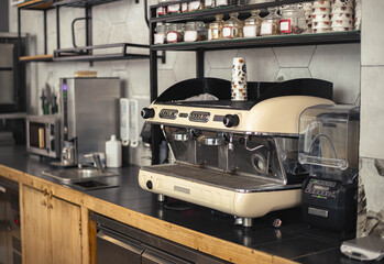 Steam rises gently as a modern coffee machine brews a rich cup of coffee in a chic cafe setting.