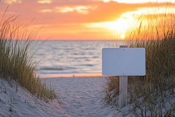 Blank signboard standing on a sandy beach at sunset, inviting you to customize your own message