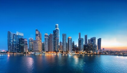 Obraz premium A panoramic view of the city skyline at dusk, showcasing tall buildings and skyscrapers against a blue sky