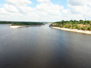 Fototapeta premium The view from the top of the rock on the blue Dnieper river that meanders between the islands and reflects its sandy shores.