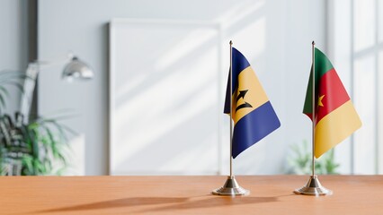 FLAGS OF BARBADOS AND CAMEROON ON TABLE