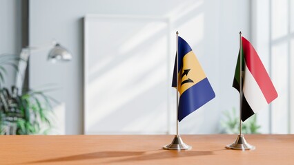 FLAGS OF BARBADOS AND SUDAN ON TABLE