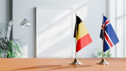 FLAGS OF BELGIUM AND ICELAND ON TABLE