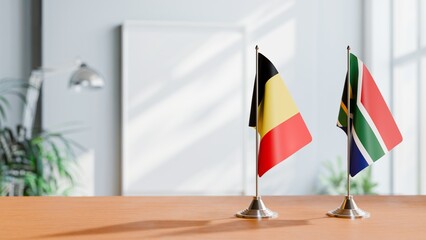 FLAGS OF BELGIUM AND SOUTH AFRICA ON TABLE