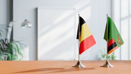 FLAGS OF BELGIUM AND ZAMBIA ON TABLE