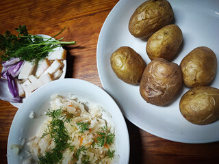 Close-up of a plate with lard, sauerkraut and boiled potatoes - homemade, organic food. Concept of traditional Ukrainian, Slavic food.