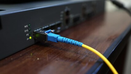 Connecting a router, router to the Internet network via an optical cable - patch cord with an adapter. Operation and reception of a network signal. Equipment for Internet services.