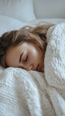Obraz premium Woman covered in blanket sleeping peacefully in bed