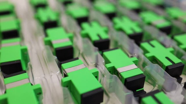 Optical adapters with different connectors in plastic blisters on the table, a batch of goods