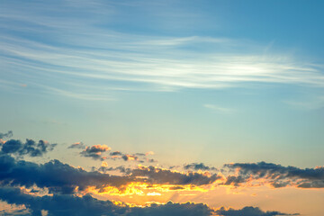 captivating twilight sky with bold streaks of orange and gold fading into a dark blue, creating a breathtaking backdrop that signifies the end of a beautiful day