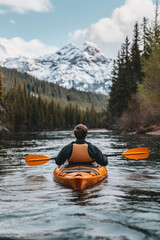 A person kayaking in lake water in winter with snow mountain