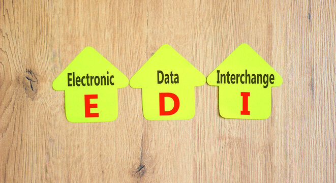 EDI electronic data interchange symbol. Concept words EDI electronic data interchange on yellow paper on a beautiful wooden background. Business and EDI electronic data interchange concept. Copy space