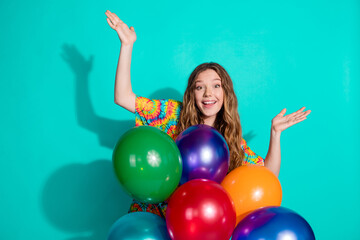 Fototapeta premium Photo portrait of lovely teen lady raise hands excited air balloons dressed stylish colorful garment isolated on cyan color background