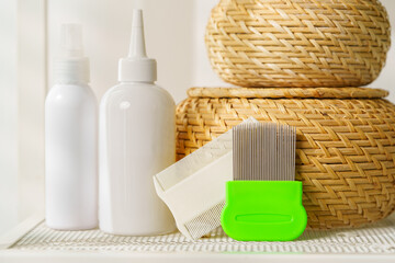 Bottles of Lice Treatment Products and a Comb on a Countertop