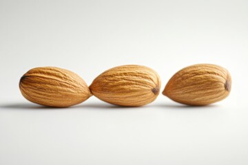 Three almonds are neatly arranged on a light background. These nuts symbolize health and nutrition. They are suitable for various culinary creations. Generative AI