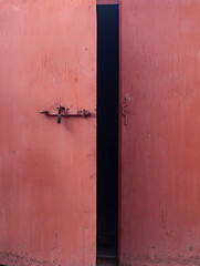 Old red iron door to the garage. Old big red iron door