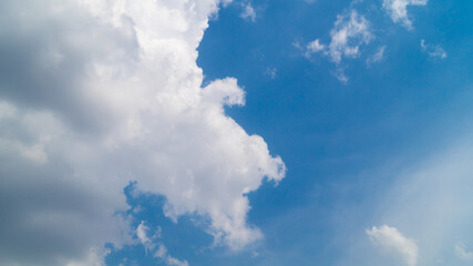 Summer blue sky and fluffy clouds