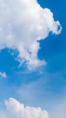 Summer blue sky and fluffy clouds