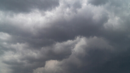 The sky is covered with gray clouds. Gray fluffy rain clouds close-up