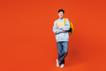 Full body young smiling cheerful happy man student he wear blue casual clothes backpack bag hold...