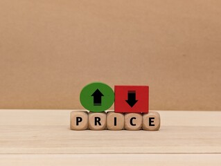 up and down arrow symbols, and the word Price on a wooden cube. the concept of changes in price increases and decreases . business finance © Nijaomei