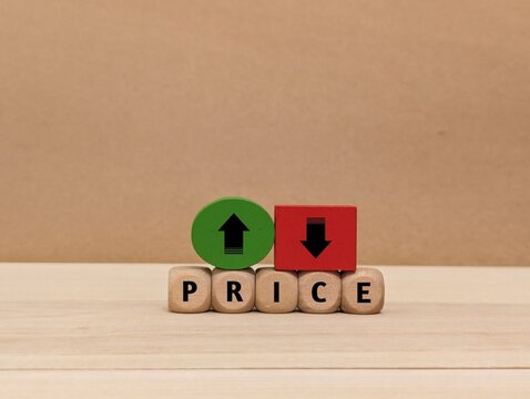 up and down arrow symbols, and the word Price on a wooden cube. the concept of changes in price increases and decreases . business finance