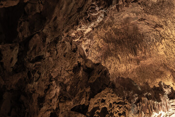 Dark cave interior with stalactites. Natural photo