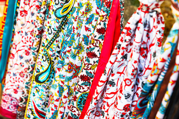 Fototapeta premium Bright shawls with colorful patterns. Assortment of a gift shop