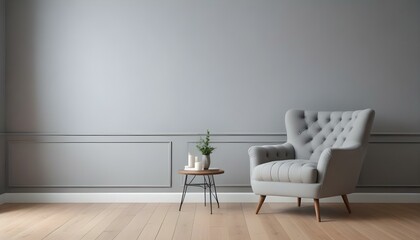 Fototapeta premium A gray tufted armchair in a minimalist living room with white walls and wooden floors.