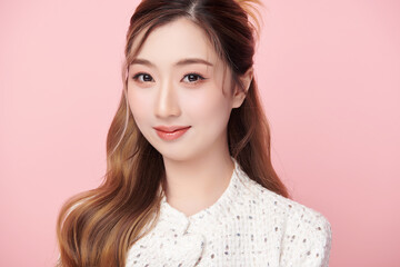 Fototapeta premium Beautiful young asian woman with clean fresh skin on pink background, Face care, Facial treatment, Cosmetology, beauty and spa, Asian women portrait.