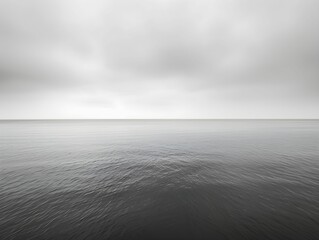 Calm overcast day at the tranquil sea with gentle ripples stretching to the horizon