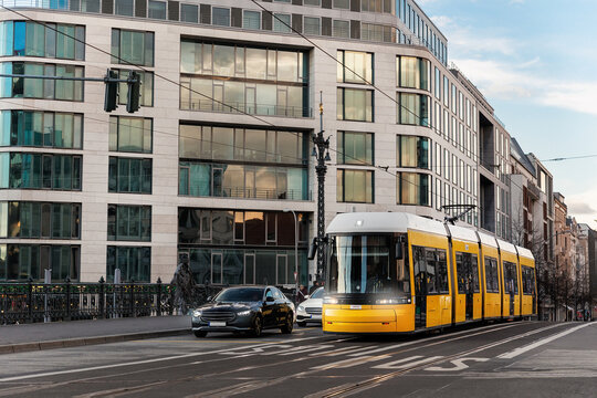 Scenic evening view Weidendammer bridge street and yellow  tram train bridge in Berlin Mitte central district at dusk sunset. Urban european transport commute cityscape Germany scene background