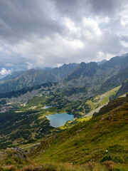 Fototapeta premium Sun is shining on the beautiful lakes and mountain peaks of the tatra national park in poland, view from Kasprowy wierch, Tatra national park, Poland