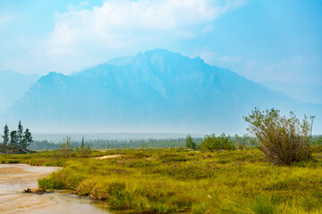 Mountain river winding through green valley