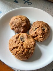 Freshly baked chocolate chip cookies, made in the oven on a plate.