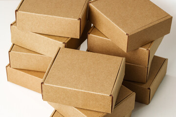 Stacked Brown Cardboard Boxes on White Surface